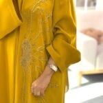 Golden yellow abaya made from high premium Barbie fabric with elegant hand-beaded floral embroidery, perfect for Eid and special occasions.