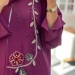 Elegant purple abaya made from high premium Barbie fabric with hand-beaded floral embroidery and 3D flower embellishments, perfect for Eid and special occasions.