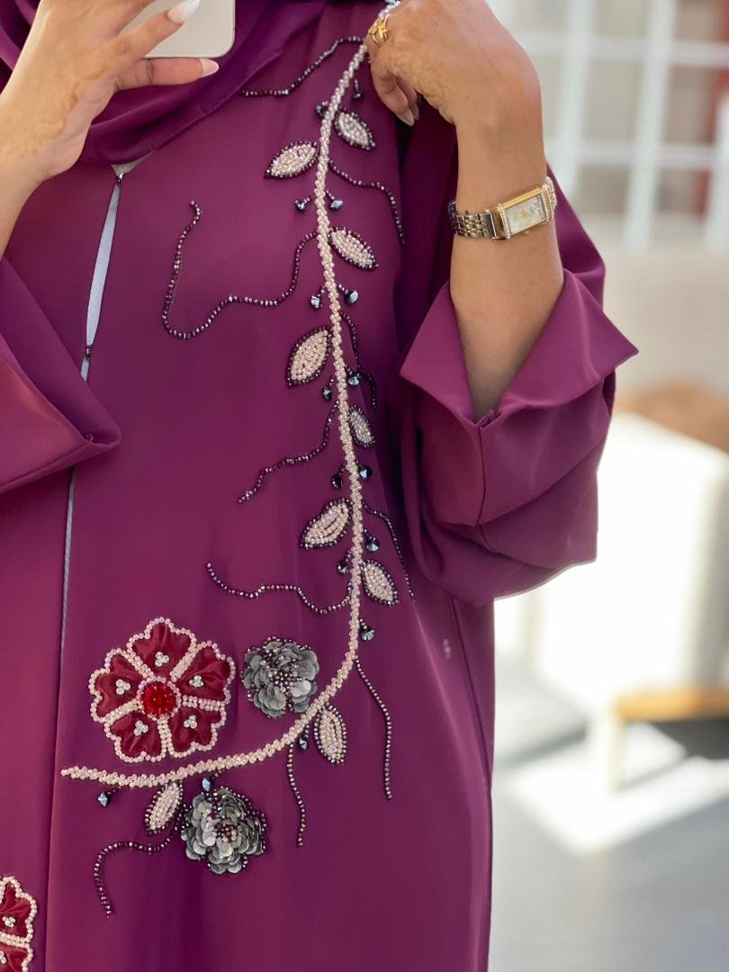 Elegant purple abaya made from high premium Barbie fabric with hand-beaded floral embroidery and 3D flower embellishments, perfect for Eid and special occasions.